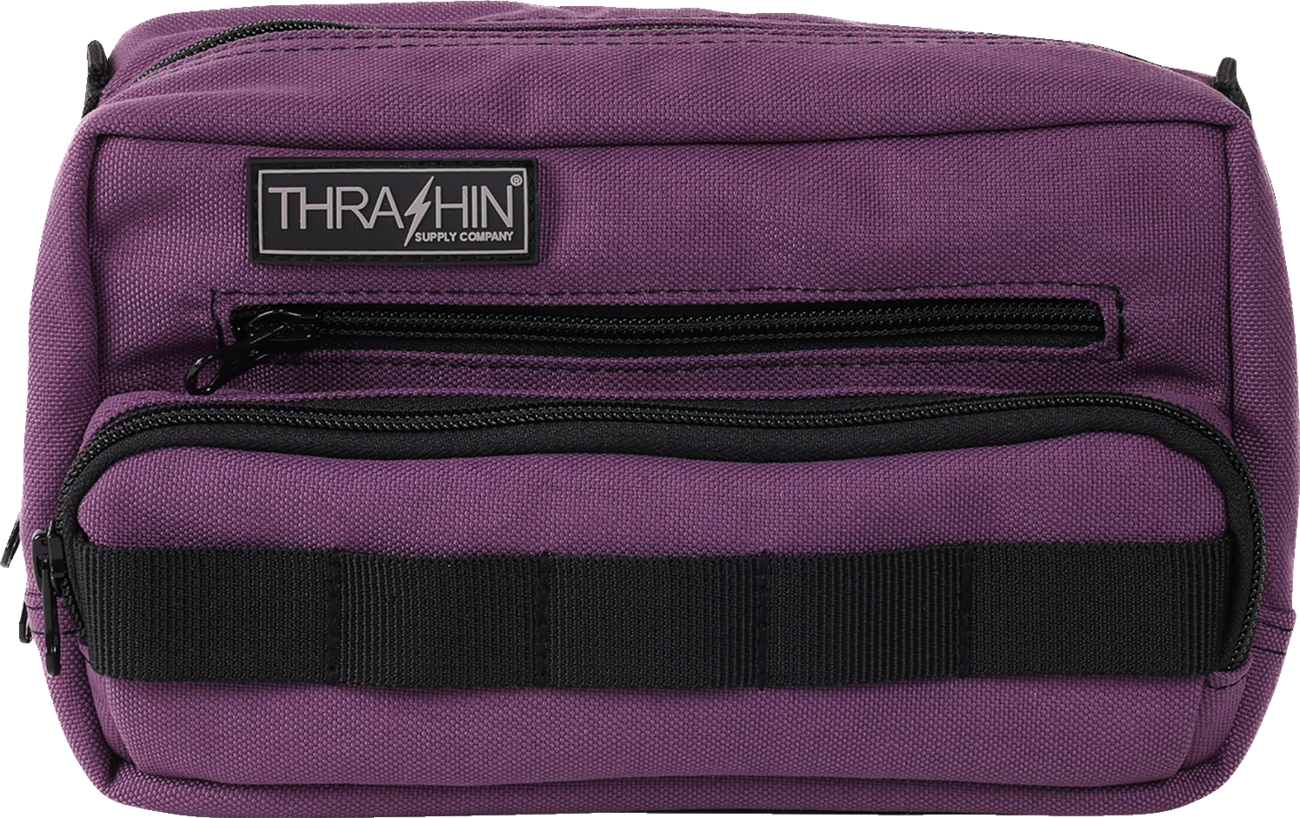 Purple THRASHIN SUPPLY CO. Handlebar Bag Plus mounted on a bike handlebar, showcasing its compact design and secure attachment