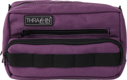 Purple THRASHIN SUPPLY CO. Handlebar Bag Plus mounted on a bike handlebar, showcasing its compact design and secure attachment
