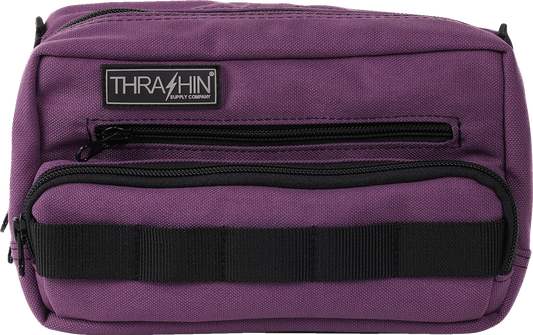 Purple THRASHIN SUPPLY CO. Handlebar Bag Plus mounted on a bike handlebar, showcasing its compact design and secure attachment