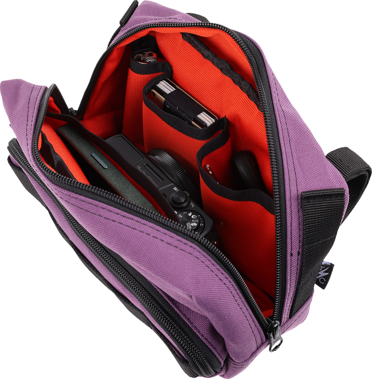 Purple THRASHIN SUPPLY CO. Handlebar Bag Plus mounted on a bicycle handlebar, showcasing its compact, durable design.