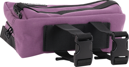 Purple THRASHIN SUPPLY CO. Handlebar Bag Plus mounted on a bicycle handlebar, featuring durable design and secure strap attachments.