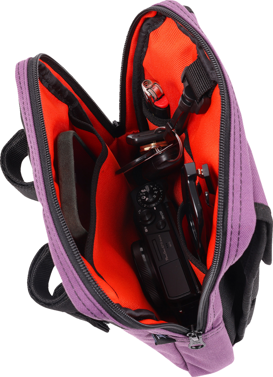 Purple THRASHIN SUPPLY CO. Handlebar Bag Slim attached to a bicycle handlebar, designed for compact storage and easy access.