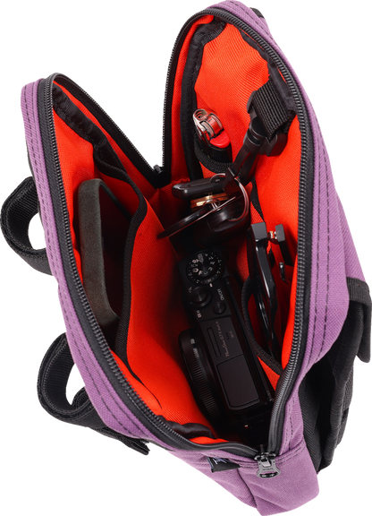 Purple THRASHIN SUPPLY CO. Handlebar Bag Slim attached to a bicycle handlebar, designed for compact storage and easy access.