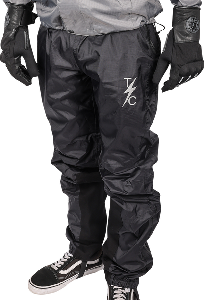 THRASHIN SUPPLY CO. Mission Rain Pants in black, size S/M, shown folded with waistband and waterproof fabric visible.