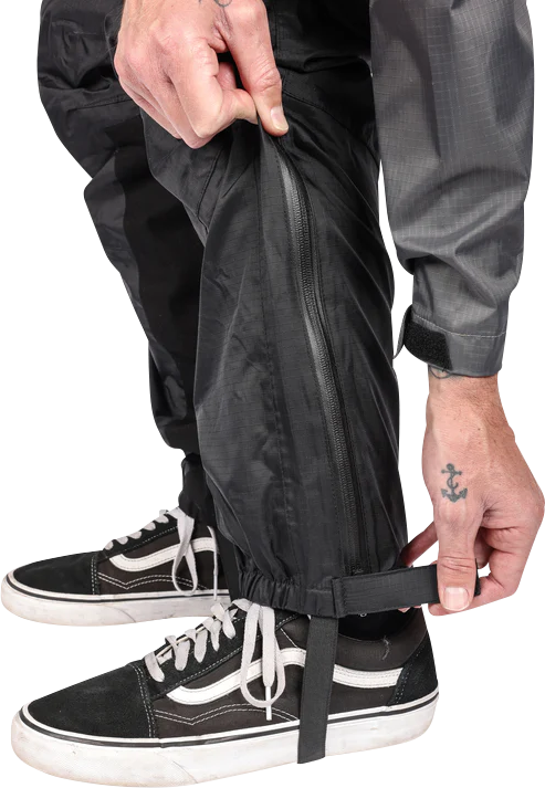 Black THRASHIN SUPPLY CO. Mission Rain Pants in size S/M, showing the waterproof fabric and adjustable waistband.