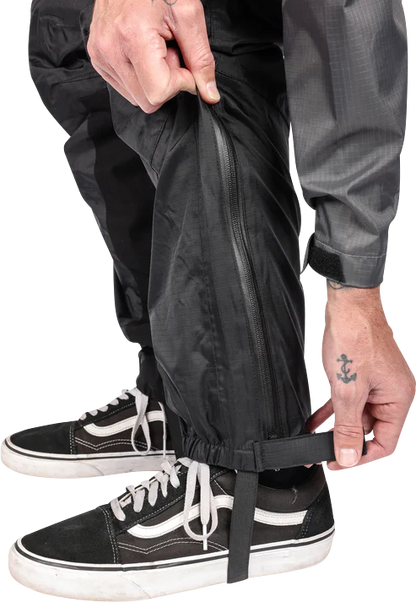 Black THRASHIN SUPPLY CO. Mission Rain Pants in size S/M, showing the waterproof fabric and adjustable waistband.