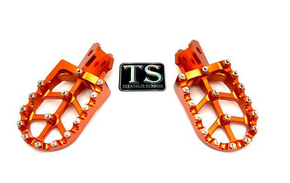 Titanium Surron 6061 TS burnt orange anodized aluminum foot pegs for Surron and e-moto bikes.