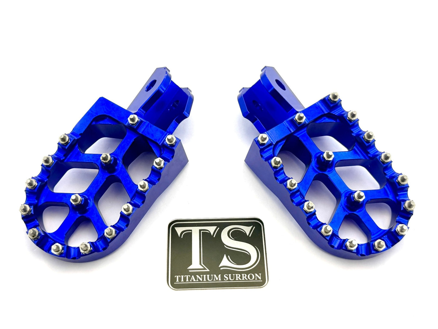 Titanium Surron 6061 TS anodized aluminum foot pegs in burnt orange for Surron and similar e-moto bikes.