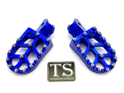 Titanium Surron 6061 TS anodized aluminum foot pegs in burnt orange for Surron and similar e-moto bikes.