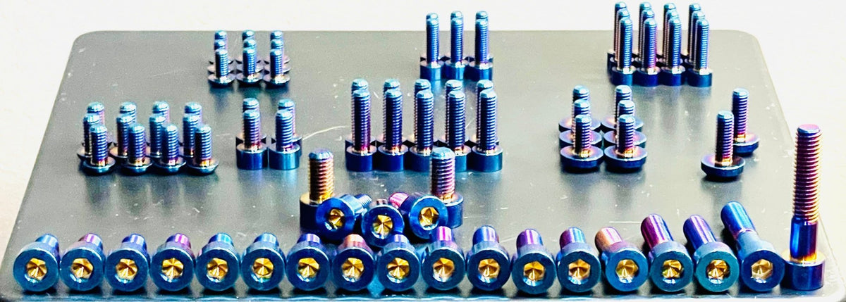 Blue titanium bolts from Titanium Surron full body kit on Altis Sigma electric bike, showcasing lightweight, durable titanium hardware.