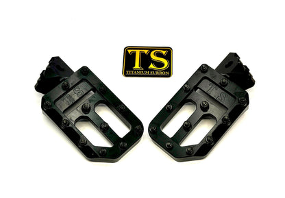 Titanium Surron custom foot pegs with titanium grips, designed for Surron, Talaria, and Altis light electric motorcycles.