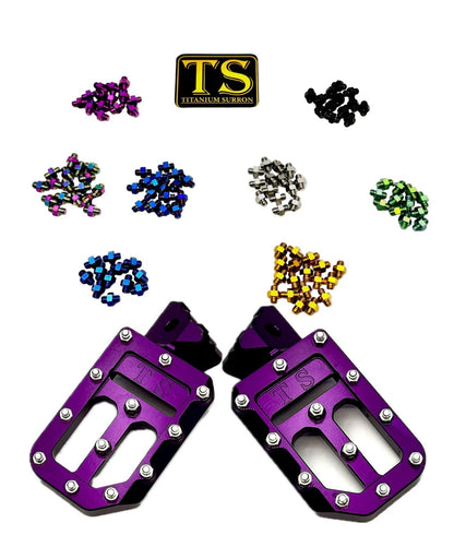 Titanium Surron custom foot pegs with titanium grips for Surron and e-moto models, showing durable metal construction and grip design.