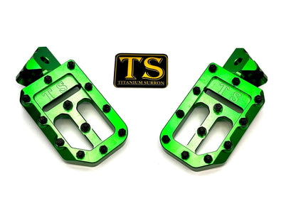 Titanium Surron custom foot pegs with titanium grips for Surron, Talaria, and Altis electric bikes, featuring durable, lightweight design.