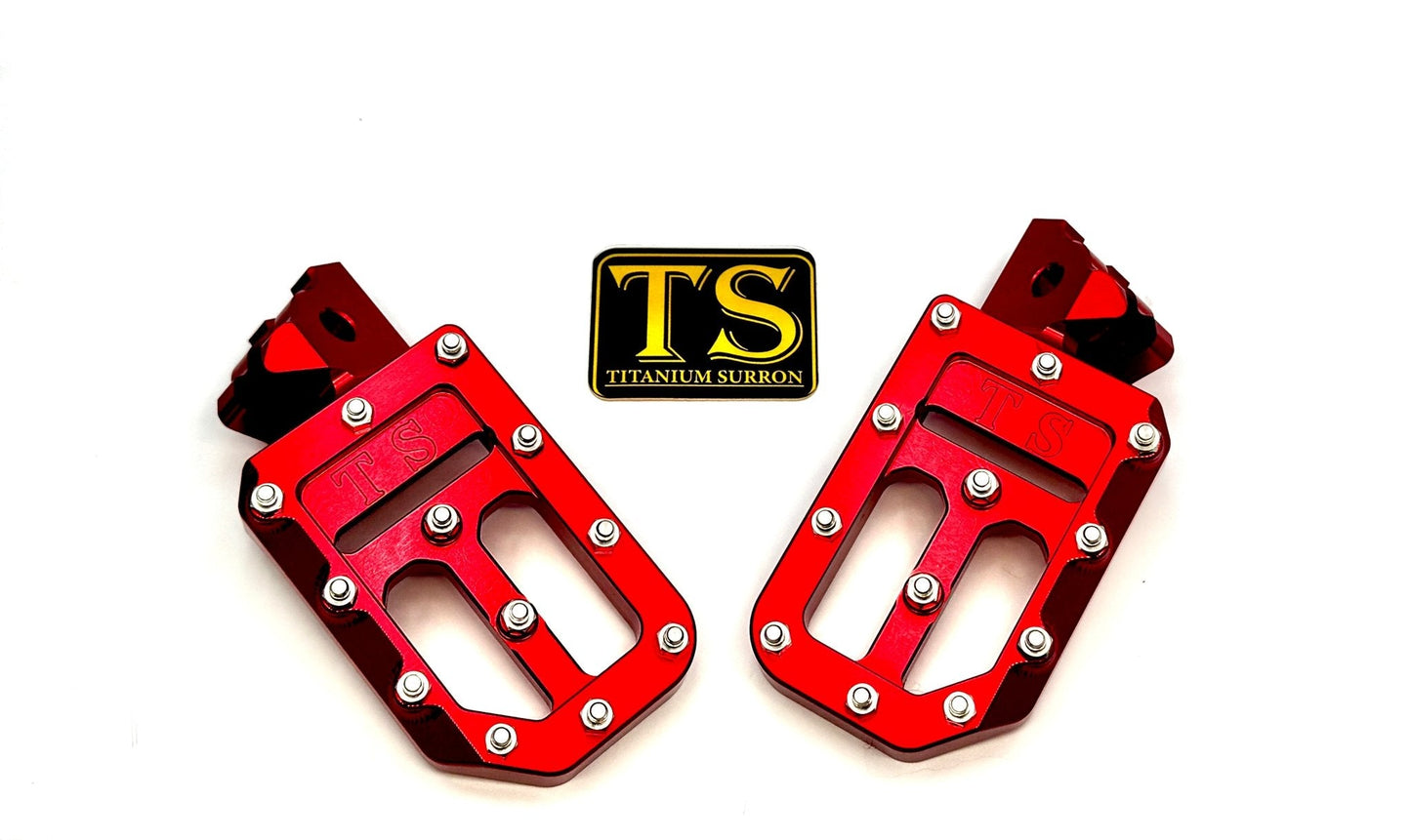 Titanium Surron custom foot pegs with titanium grips for Surron and light e-moto bikes, featuring durable metal construction.