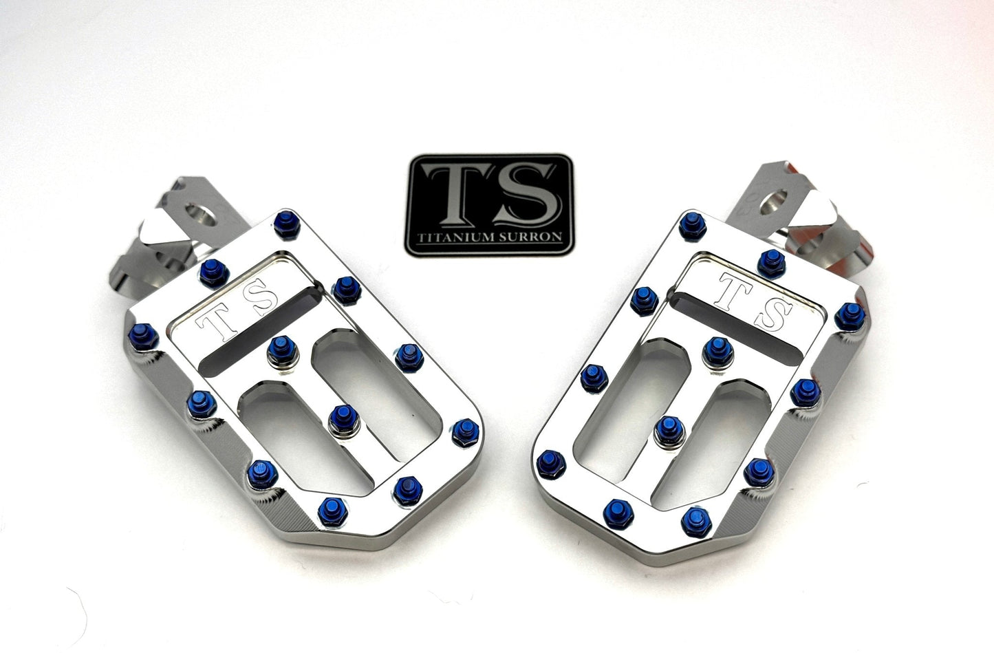 Titanium Surron custom foot pegs with titanium grips for Surron, Talaria, and Altis electric motorcycles, featuring lightweight alloy construction.