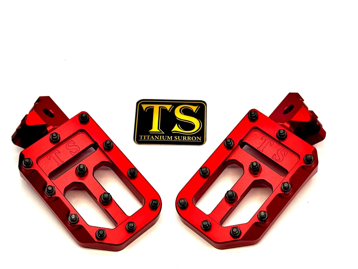 Titanium Surron custom foot pegs with titanium grips for Surron and light e-moto bikes, featuring durable metal construction.