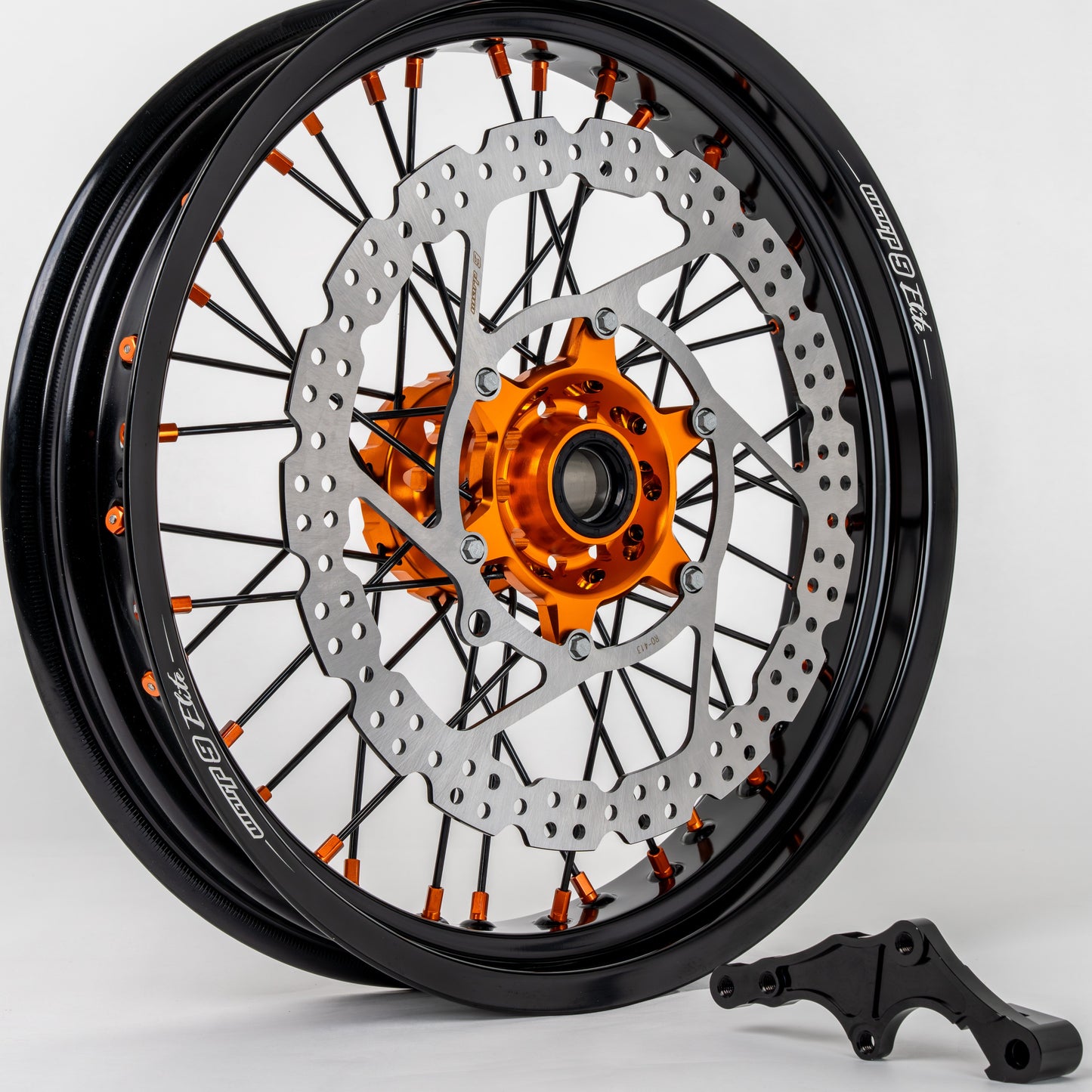 Warp9Racing early KTM front 17-inch wheel in orange, black, and silver, designed for KTM motorcycle fitment.