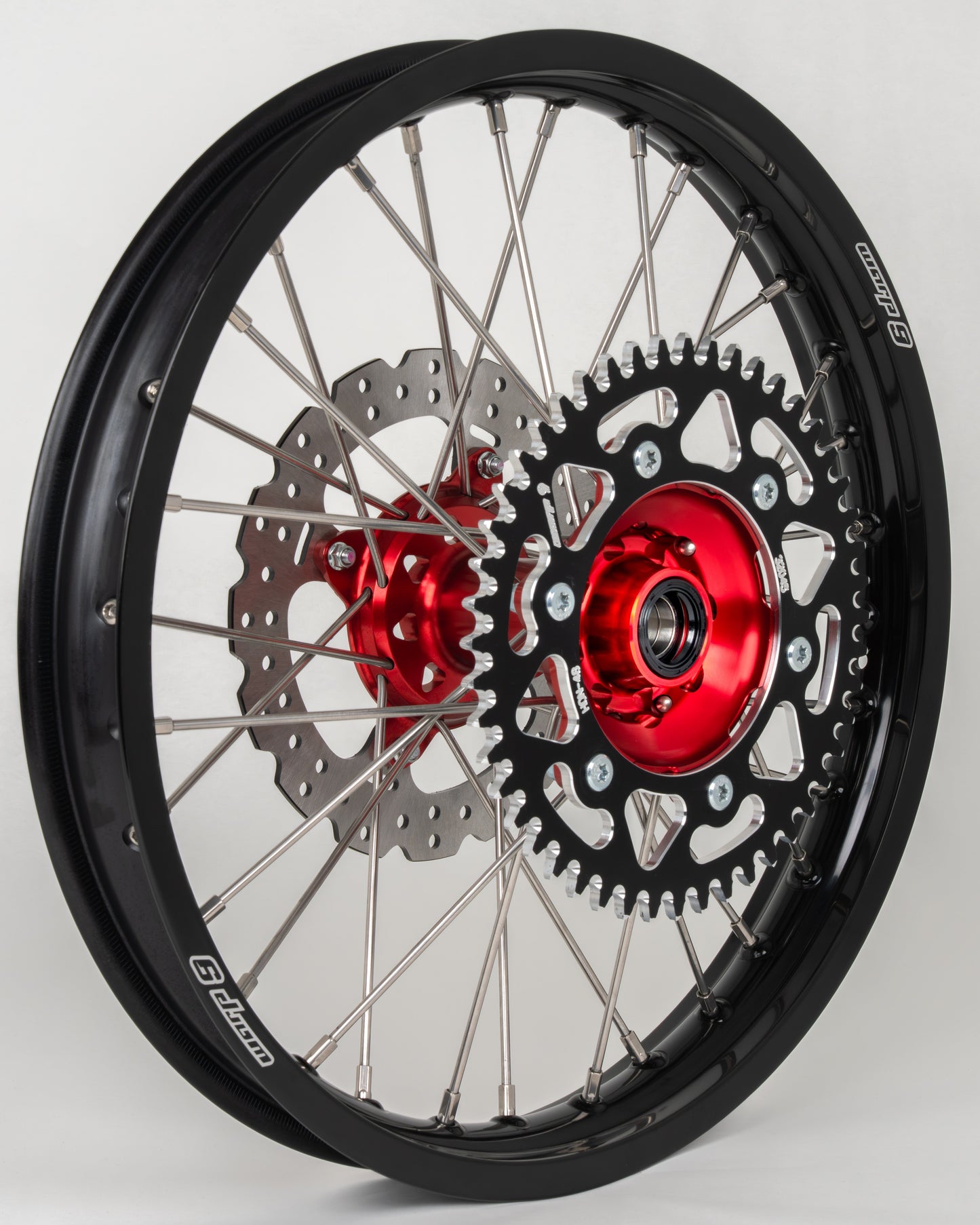 Honda CRF rear wheel by Warp9Racing, 19x2.15 inch, red, black, silver finish with 38T sprocket, in stock for fitment.