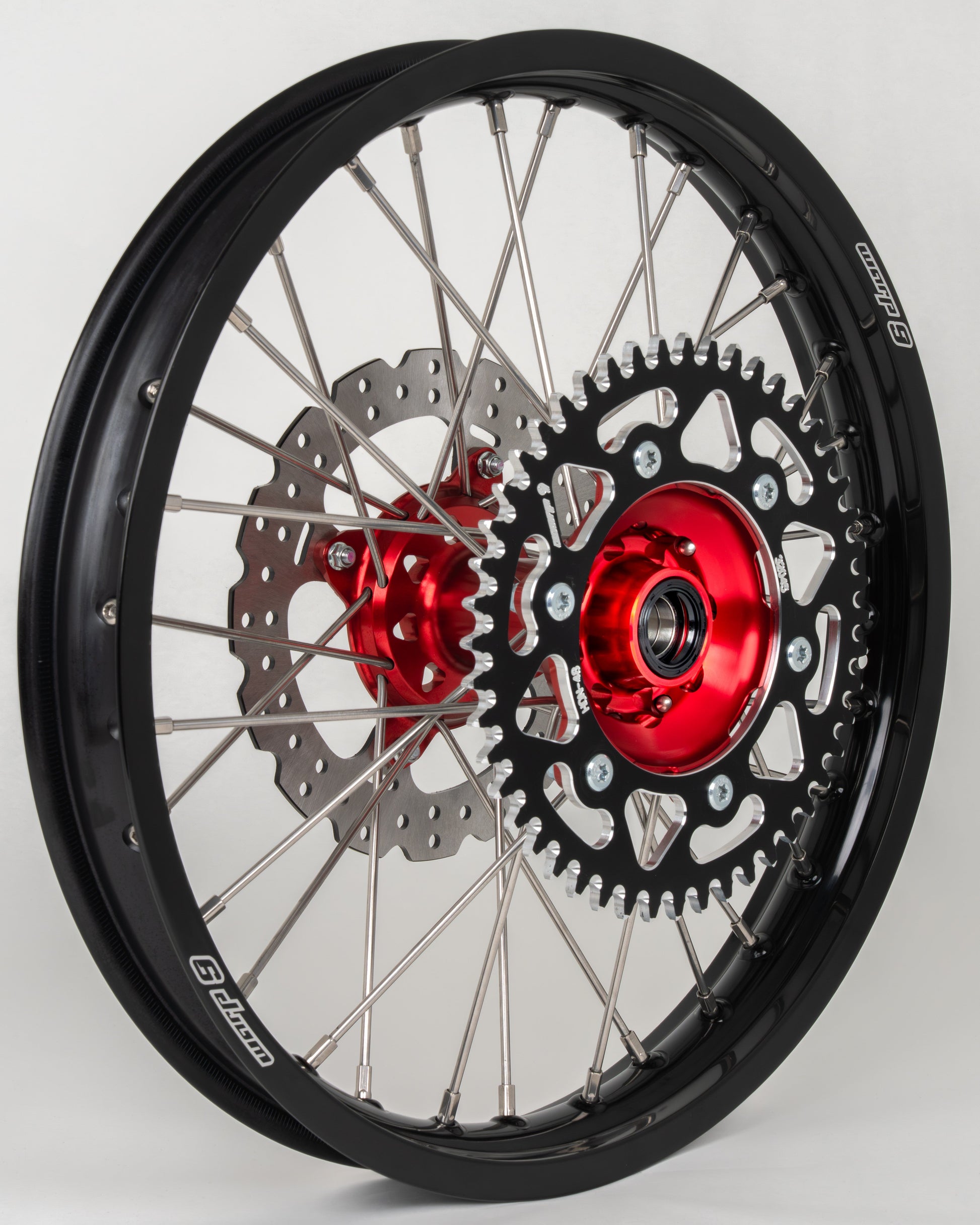 Honda CRF rear wheel by Warp9Racing, 19x2.15 inch, red, black, silver finish with 38T sprocket, in stock for fitment.
