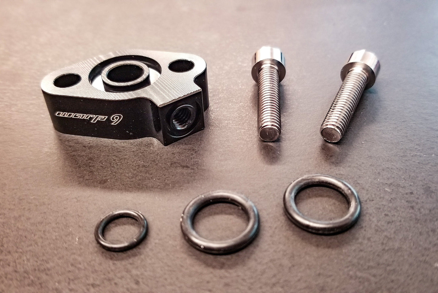 Warp9Racing oil sensor for collecting oil temperature data, featuring a compact design and durable build.