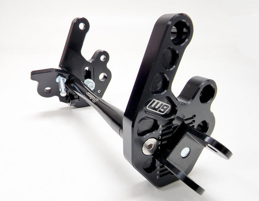 Warp9Racing adjustable foot peg mount for Sur-ron LBX and 79Bike, shown in a close-up image highlighting the sturdy construction.