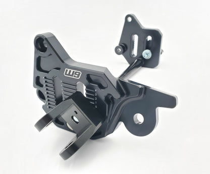 Warp9Racing adjustable foot peg mount for Sur-ron LBX and 79Bike, shown mounted on the bike with a sturdy metal construction.