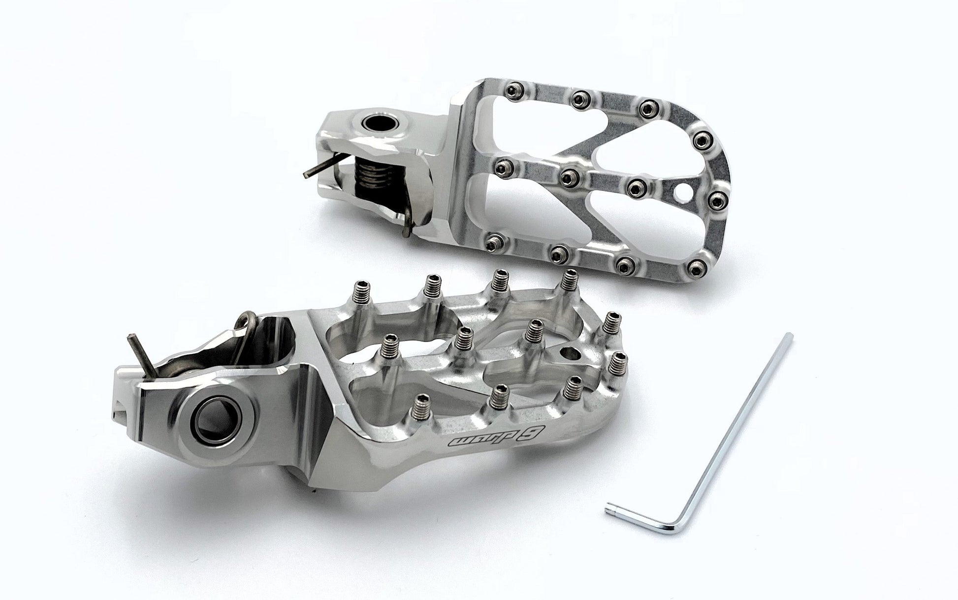 Warp9Racing silver Stark Varg Elite foot pegs for electric motorcycle, showcasing durable metal construction and secure mounting.