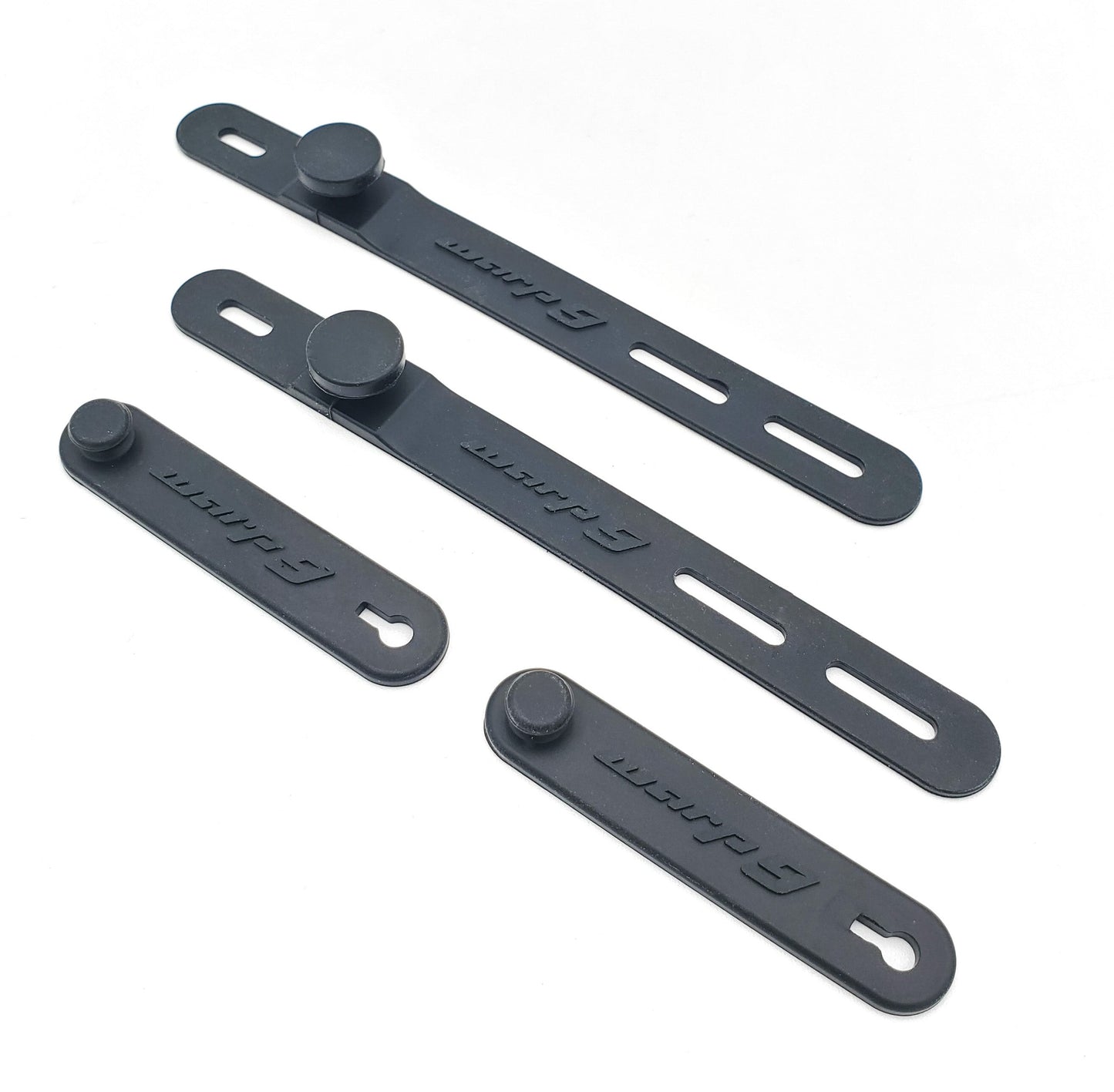 Warp9Racing Surron bar straps for handlebars, black silicone grips with textured surface and adjustable mounting for secure fit.
