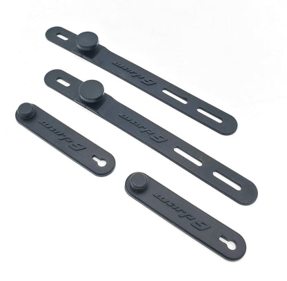 Warp9Racing Surron bar straps for handlebars, black silicone grips with textured surface and adjustable mounting for secure fit.