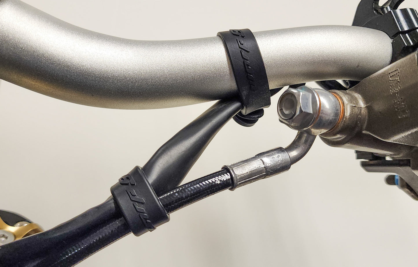 Warp9Racing Surron bar straps, black lightweight motorcycle handlebar straps with secure fastening for off-road riding.