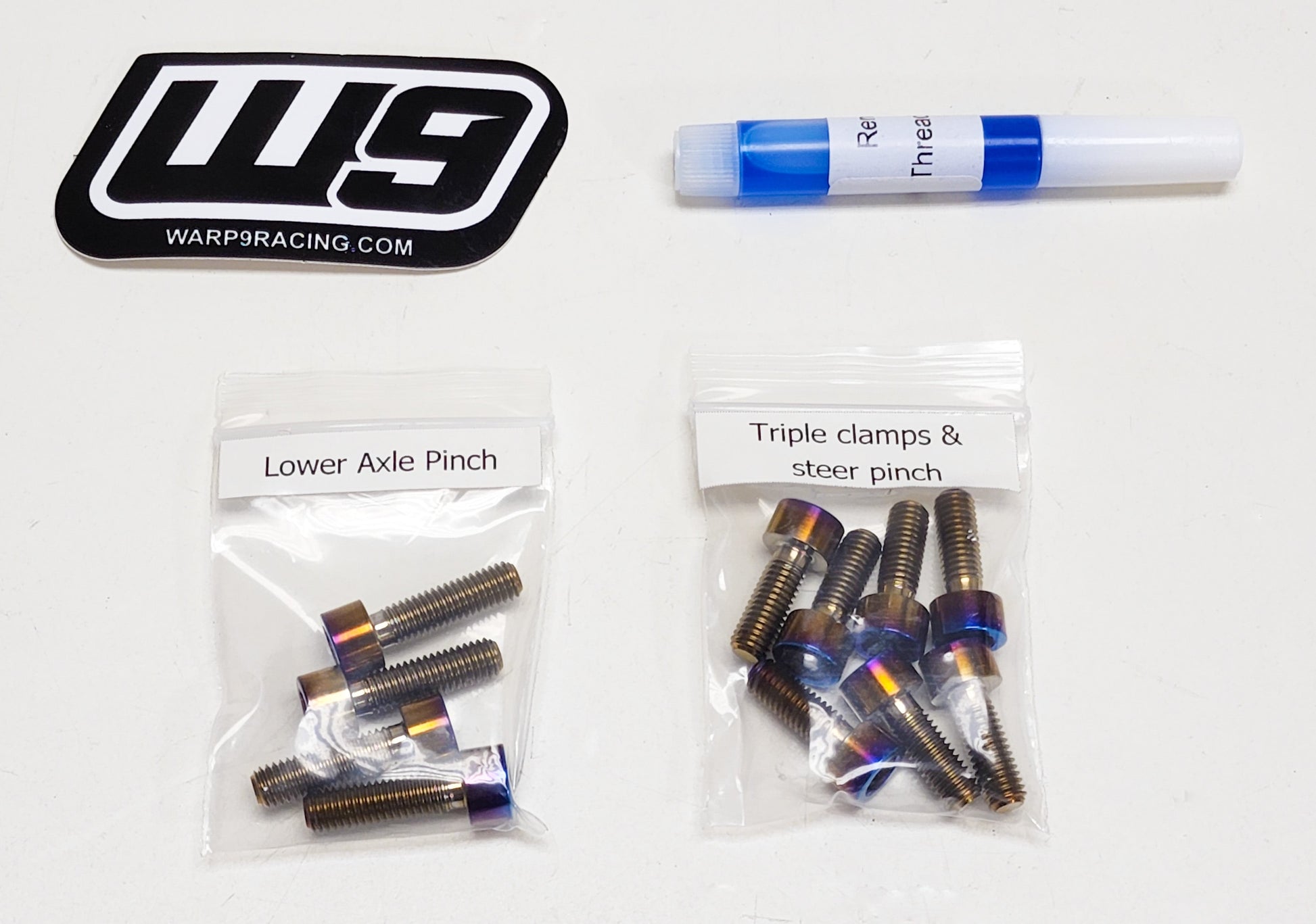 Set of Warp9Racing titanium fork bolts for Surron and Talaria electric bikes, designed for Fox 40 forks.