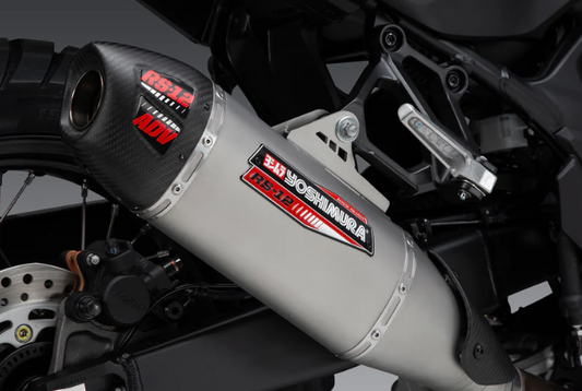 YOSHIMURA RS12 Muffler Badge attached to a motorcycle exhaust, displaying the authentic Yoshimura logo and model identification.