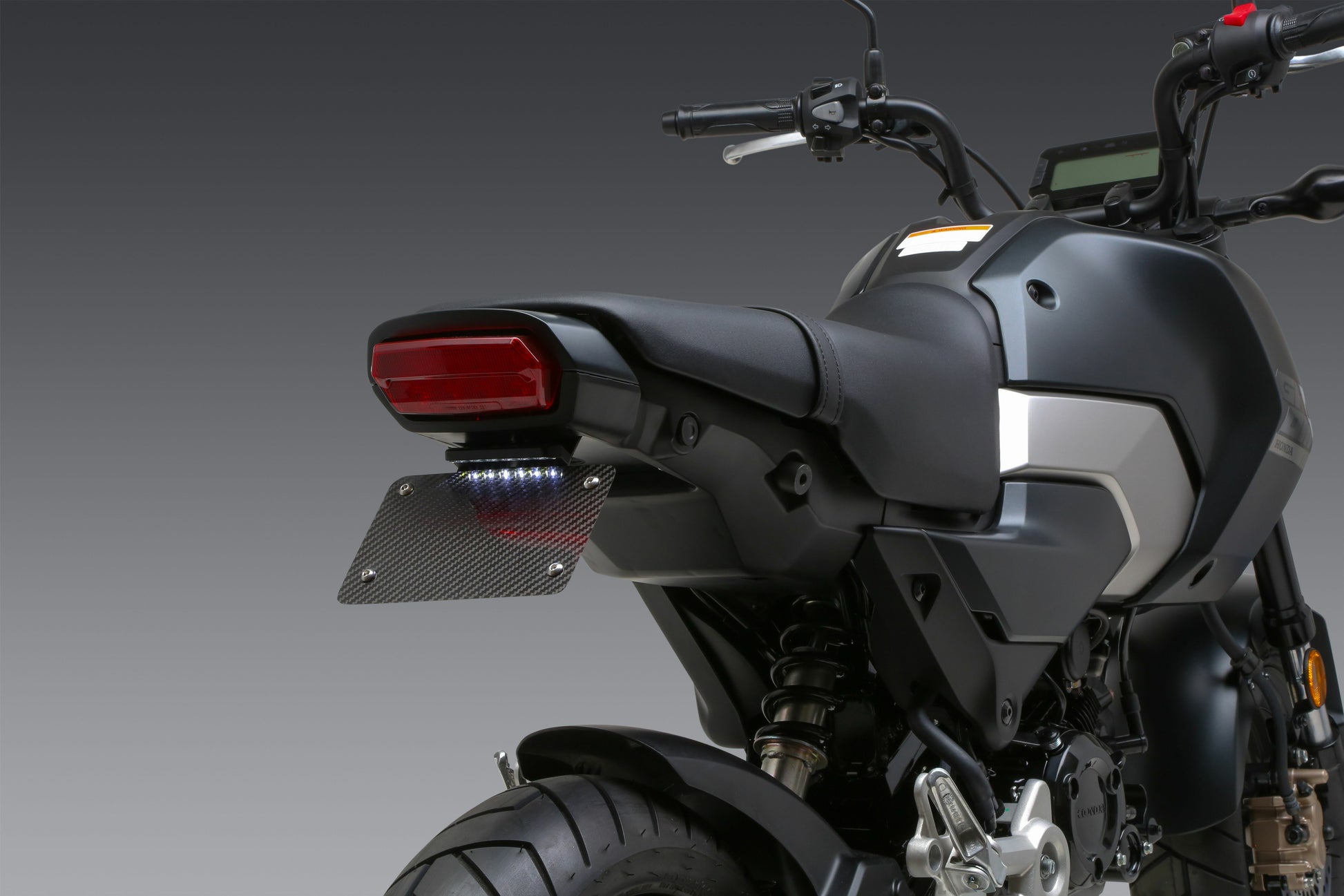YOSHIMURA V2 Fender Eliminator Kit for Honda motorcycle, showing sleek black design and mounting hardware.