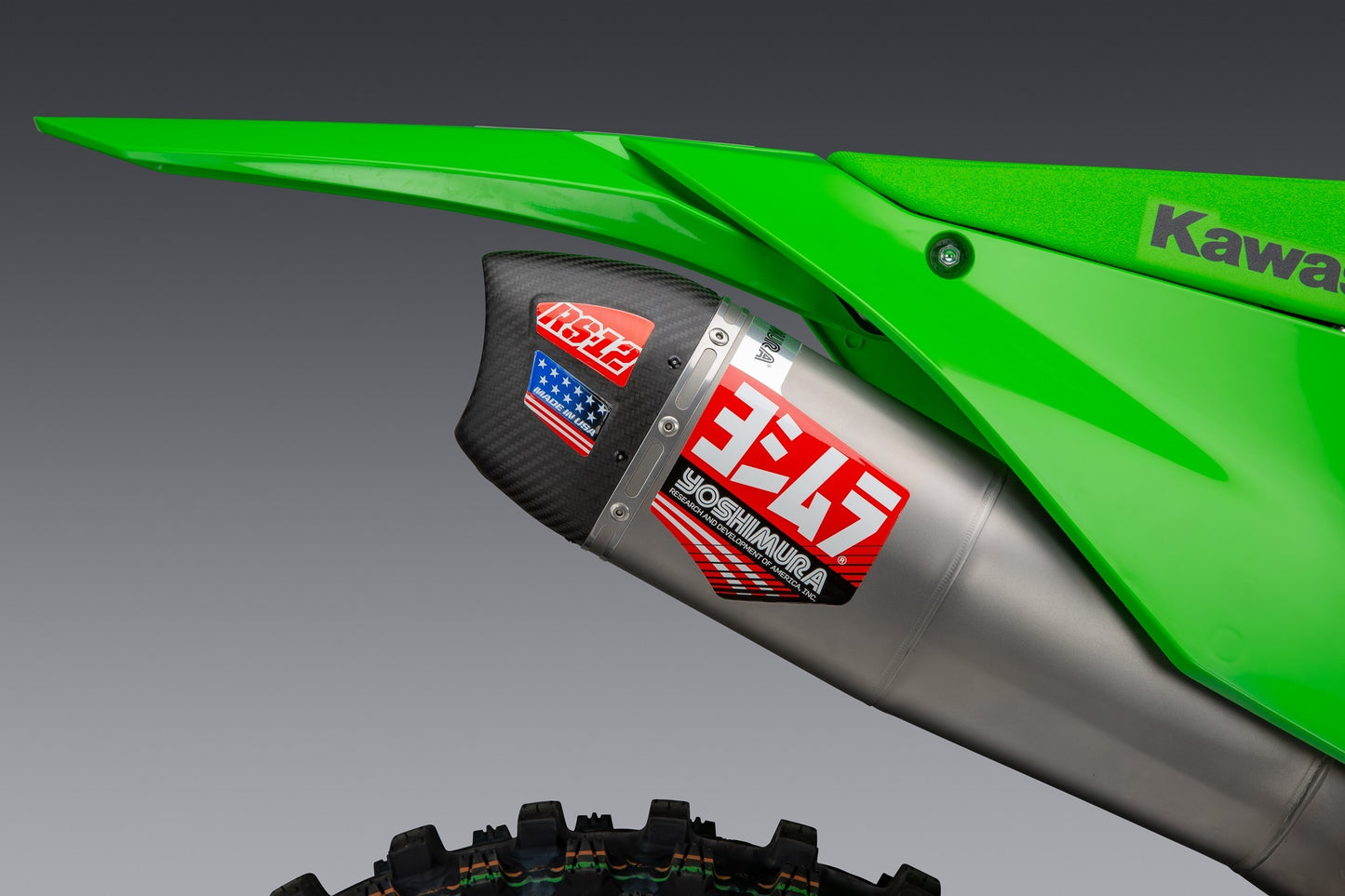 Yoshimura RS-12 motorcycle exhaust system for Kawasaki KX450, stainless steel, aluminum, and carbon fiber components, front view.